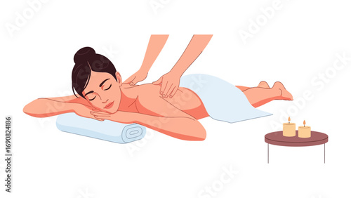 Relaxed young woman receiving a soothing back massage on a spa table with towels and essential oils nearby