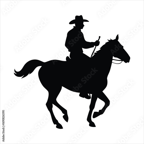 Silhouette of a cowboy riding a horse at a trot