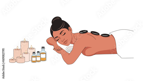 Relaxed woman receiving a soothing hot stone massage therapy treatment with aromatherapy oils and candles for ultimate spa wellness