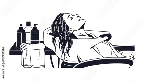 Relaxed woman enjoying a hair washing experience at a salon with towels and bottles in the background