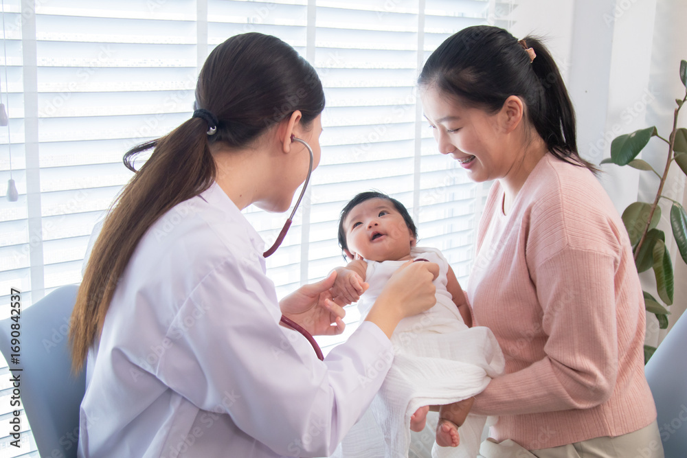 Fototapeta premium Newborn baby with mother during pediatric checkup, female doctor using stethoscope for medical examination, healthcare service, family bonding, protection, illness, and wellness in clinic environment