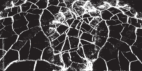 Abstract monochrome grunge texture with a network of glowing white cracks and fissures on a dark surface.