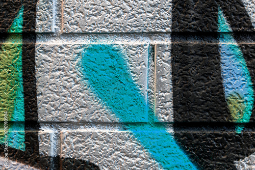 Beautiful bricks colorful street art graffiti background. Abstract gradient spray drawing fashion colors on the brick walls of the city. Urban metallic , red , white , grey , bright texture