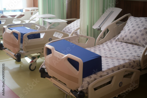 Empty beds in a hospital ward. Medical care, healthcare system, and patient recovery concept. Room with modern hospital beds for clinic.