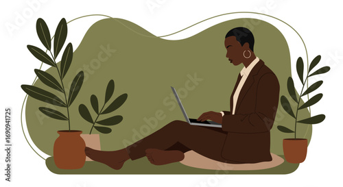 A professional African American woman works on her laptop in a relaxed home office setting with plants, showcasing remote work flexibility and productivity.