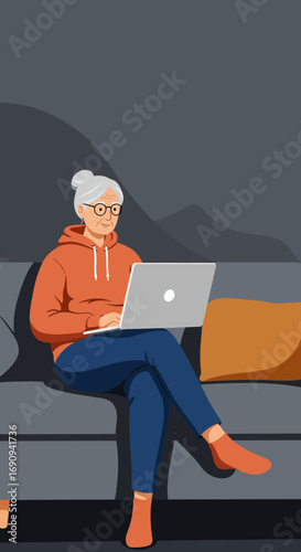 Elderly woman comfortably using a laptop on a sofa at home, embracing technology for leisure, learning, or staying connected. Modern senior lifestyle.