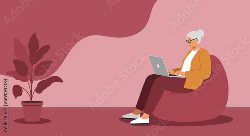 An older woman comfortably uses a laptop on a bean bag chair, illustrating remote work, online learning, or digital engagement for seniors in a modern home setting.