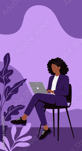Professional African American woman focused on working with her laptop, sitting in a stylish purple environment with plants. Ideal for business, technology, and remote work concepts.