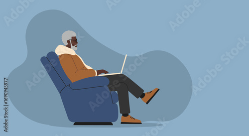Senior Black man relaxed in a comfy armchair, actively using a laptop for leisure or remote work. Modern technology for an older generation.