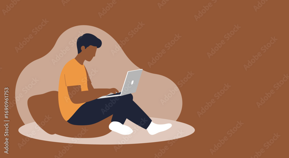 Fototapeta premium Young man works remotely on his laptop from a comfortable home setting. Ideal for themes of online education, freelance work, or digital lifestyle.