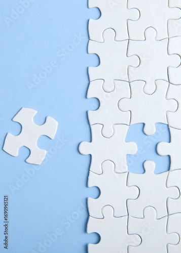 White puzzle on a colored background top view.. Vertical photo format