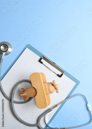  Pediatrics concept. Stethoscope and toy on a light background. Vertical photo format