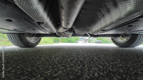 Low angle of the car passing above the camera. Video from underneath beneath the car.
