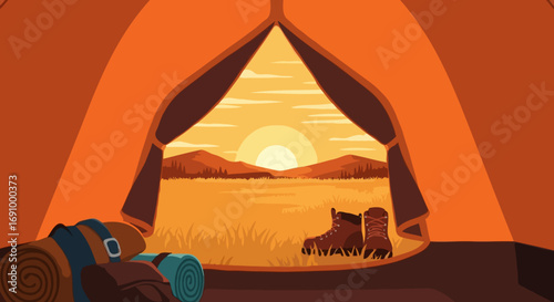 View from a tent of a desert sunset with boots and backpack