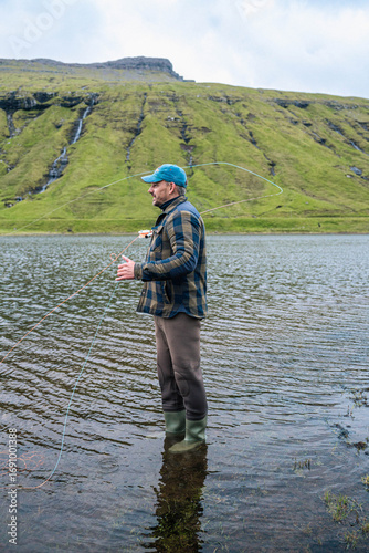 Man Fly Fishing in Mountain Lake on the Faroe Islands