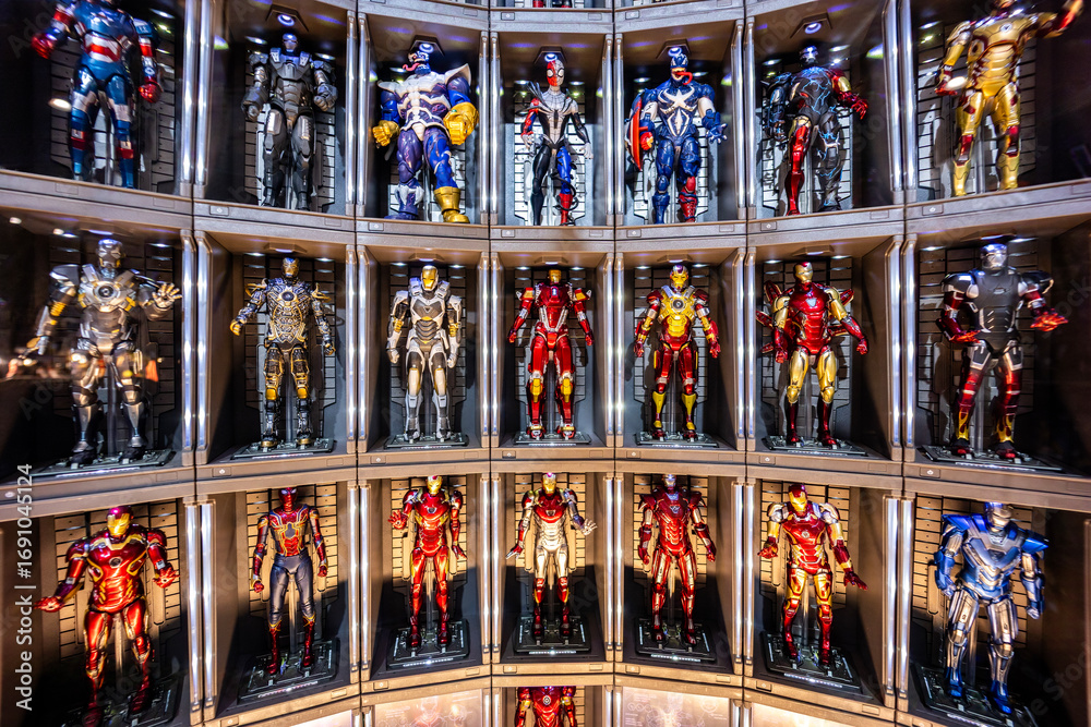 Naklejka premium Bangkok, Thailand - September 4, 2025 : A display of multiple iconic Iron Man, Venom and Spider Man suits arranged in a futuristic setup. Avenger Marvel Concept.