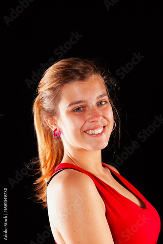 Young and beautiful woman at studio with black backgound