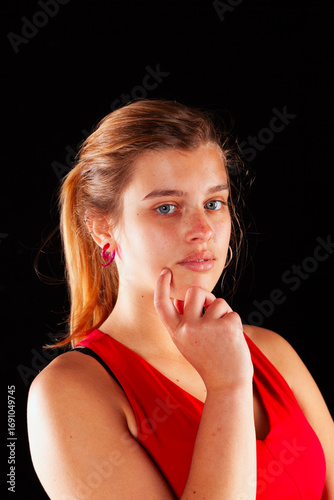 Young and beautiful woman at studio with black backgound