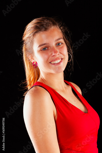Young and beautiful woman at studio with black backgound
