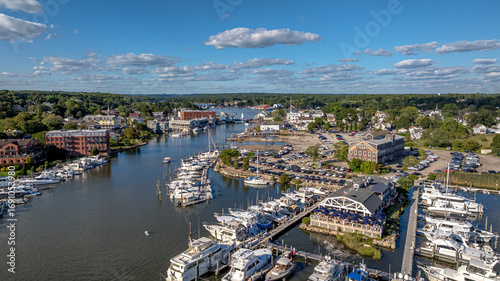 Mystic River, Mystic Connecticut. Aerial view overlooking the mouth of the river with boats in the marina, local businesses and architecture and a view of Mystic Seaport in the distance.