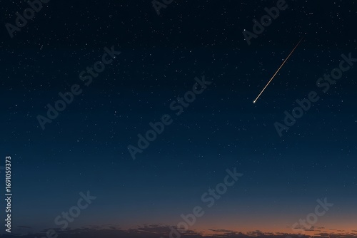 Bright shooting star is streaking across the night sky. The sky is dark and filled with stars