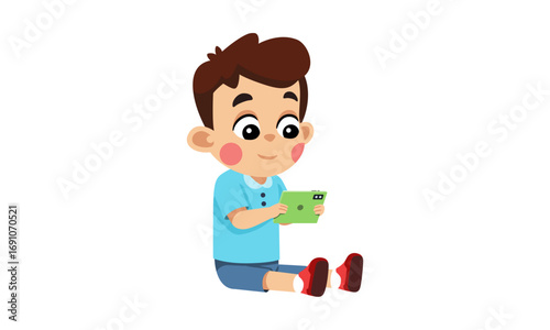 A cute boy sits and plays with a tablet.