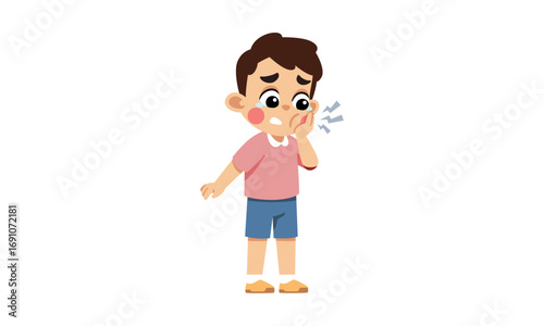A young boy with a toothache, holding his cheek.