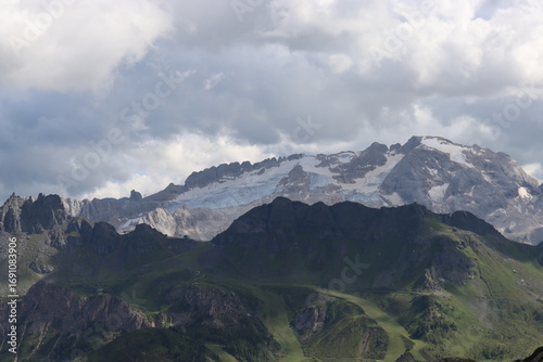 Trentino, Italy - July 29, 2025: Stunning Alpine scenery of breathtaking Dolomites rocks mountains in Italian Alps. Marmolada glacier seen in the distance from the slopes of the Porta Vescovo Dolomite