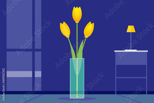 yellow tulips in a tall  slender crystal vase in a