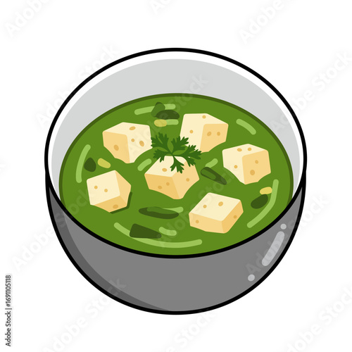 Bowl of palak paneer sitting on a white surface, garnished with fresh herbs, offering a comforting and flavorful vegetarian meal experience.