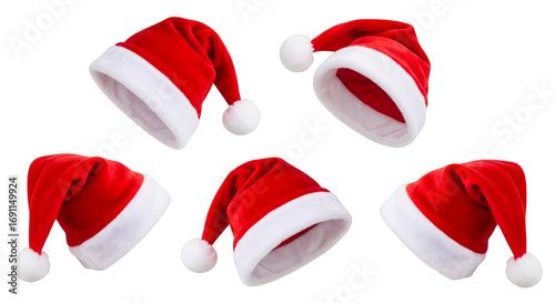 Five classic red and white santa claus hats with fluffy pom poms isolated on transparent background