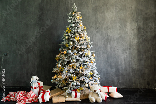 Christmas tree decorated with garlands, toys and gifts for the new year
