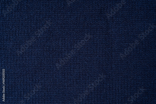 Navy blue merino wool sweater texture as background. Top view.
