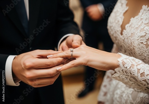 Groom places wedding ring on bride s finger during ceremony