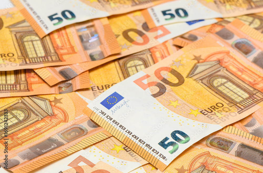 Fototapeta premium Background of fifty euro bills scattered on table