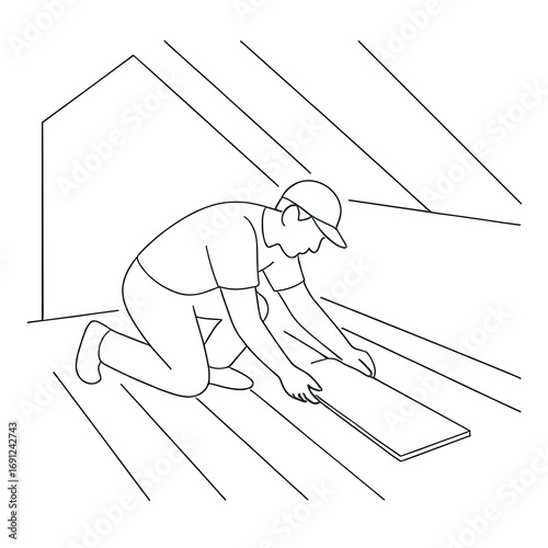 Man installing laminate flooring in attic during home renovation  