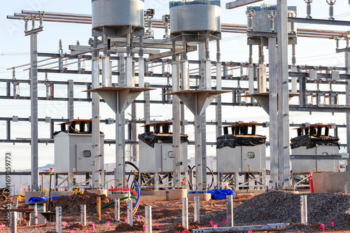Utility-scale battery energy storage facility under construction with transformers, metal framework, and electrical infrastructure to enhance grid stability and regional power capacity