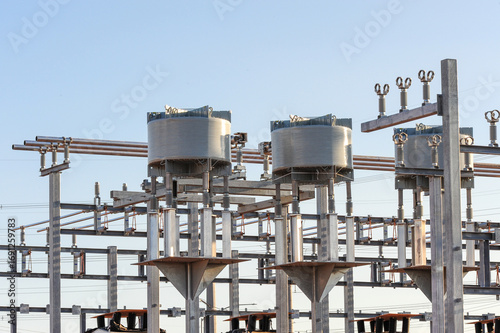 Utility-scale battery energy storage facility under construction with metal framework and electrical components designed to enhance grid resiliency and support regional power demands
