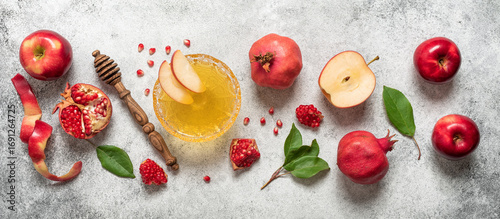 Apples, pomegranate and honey on a light rustic background. Traditional Jewish food. New Year - Rosh Hashanah. Top view, flat lay, banner.