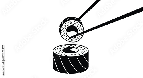 Chopsticks carefully lift a fresh sushi roll over a delicious platter.