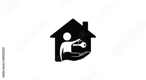 Hand holding a key in front of a house silhouette, symbolizing home ownership and real estate
