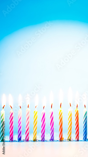 Colorful birthday candles with glowing flames, creating a festive and celebratory atmosphere.
