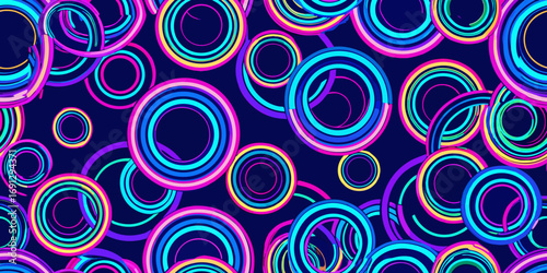 A vibrant pattern of concentric circles in shades of blue, pink, and yellow on a dark blue background
