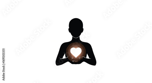 Silhouette of a person holding a glowing heart symbolizing love and compassion.