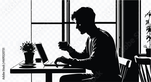 Silhouette of a focused person working on a laptop and holding a coffee cup by a window.