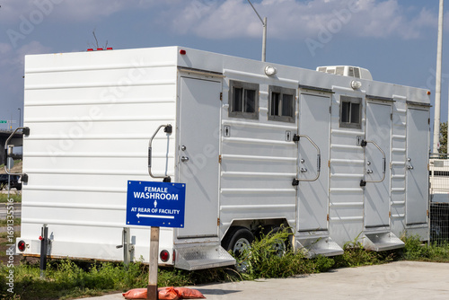 A luxury air conditioned toilet trailer at a construction site with male and female sections