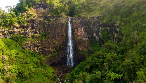Lush waterfall cascading down rocky mountainside