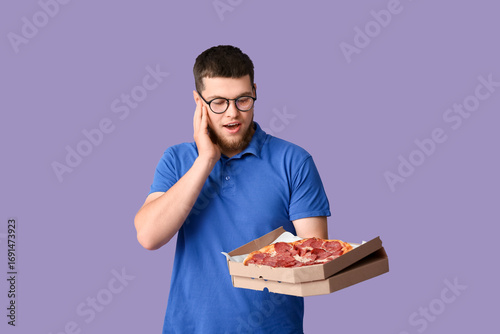 Young man holding cardboard...