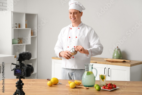 Male chef recording video o...