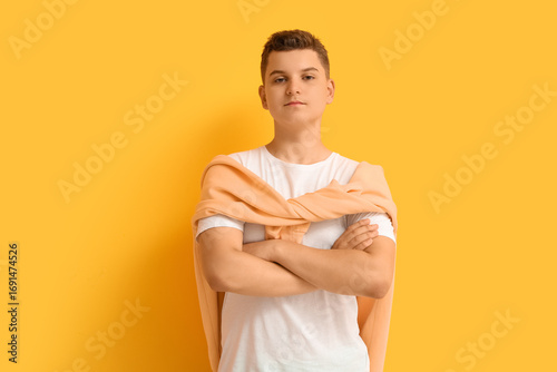 Teenage boy with crossed ar...
